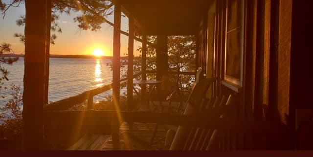 Cabin porch overlooking the lake at sunset