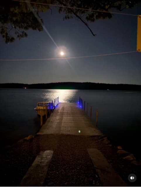 Moonlit dock on Lake Winnipesaukee at night
